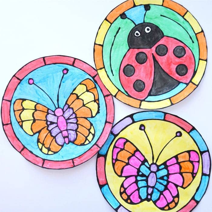 Celebrate the spring season by creating this colorful black glue spring art project. The round, stained glass templates have a fluttering butterfly or a cute ladybug in the center. See how easy it is to create this faux stained glass look with black glue and watercolors.